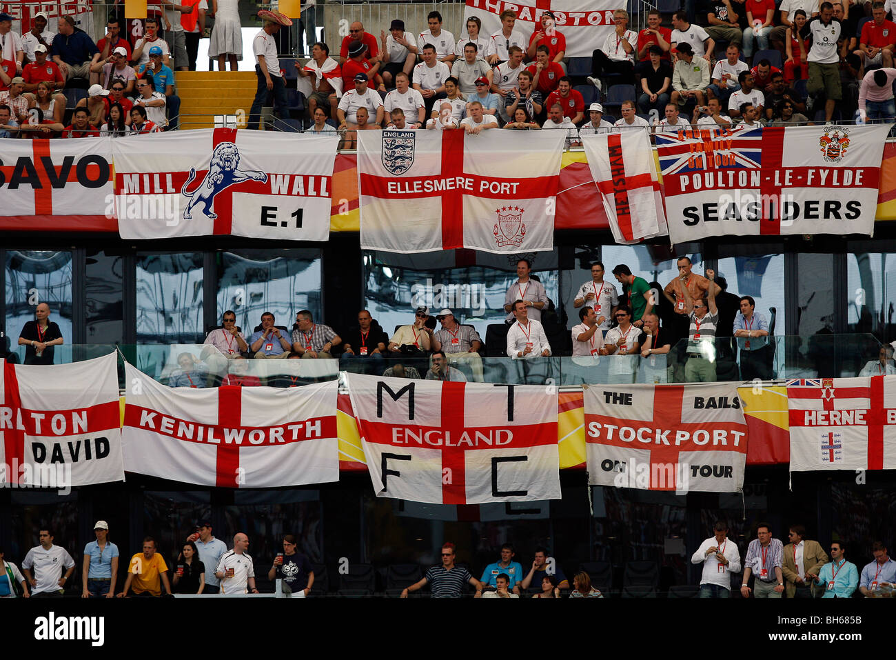 Football supporters' flags draped across a stadium stand